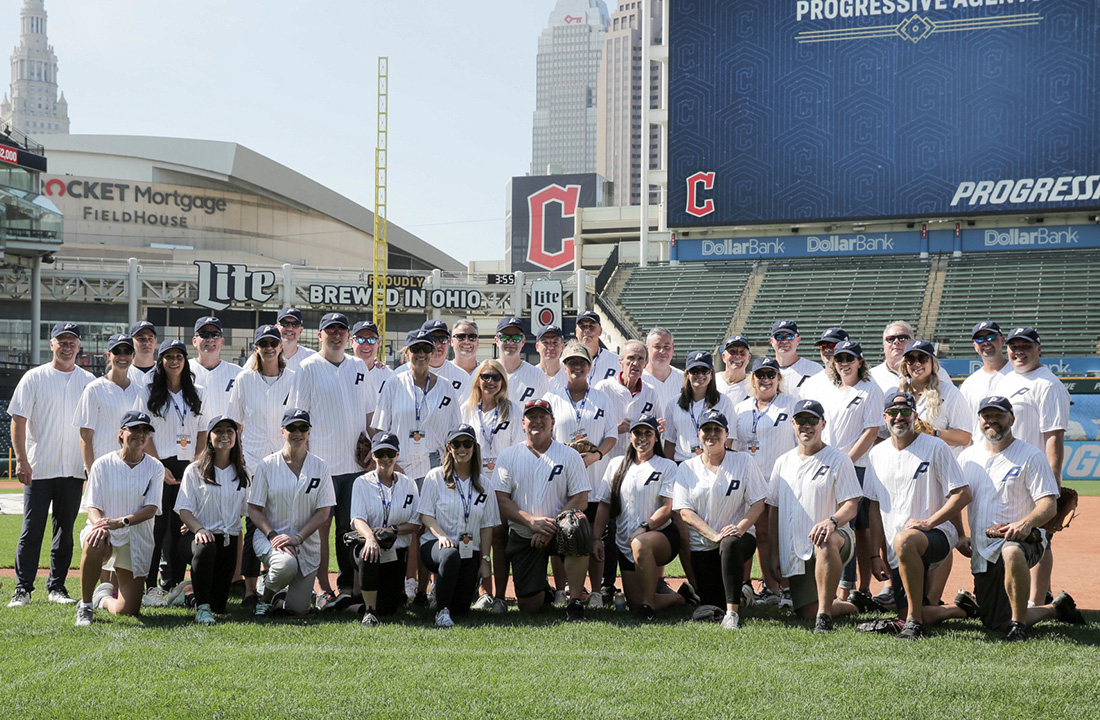 a group shot of Progressive agents on Progressive baseball field